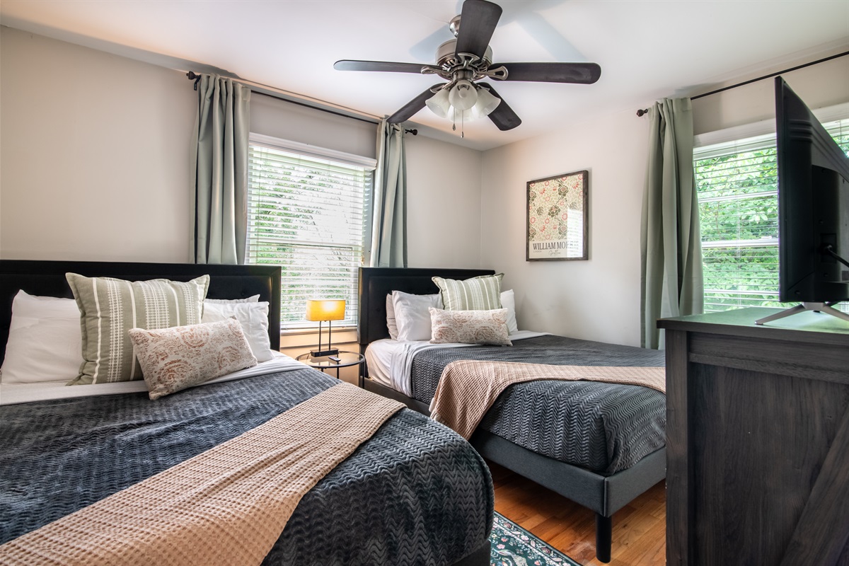 Cozy queen bedroom with ceiling fan and soft lighting — ideal for restful nights.