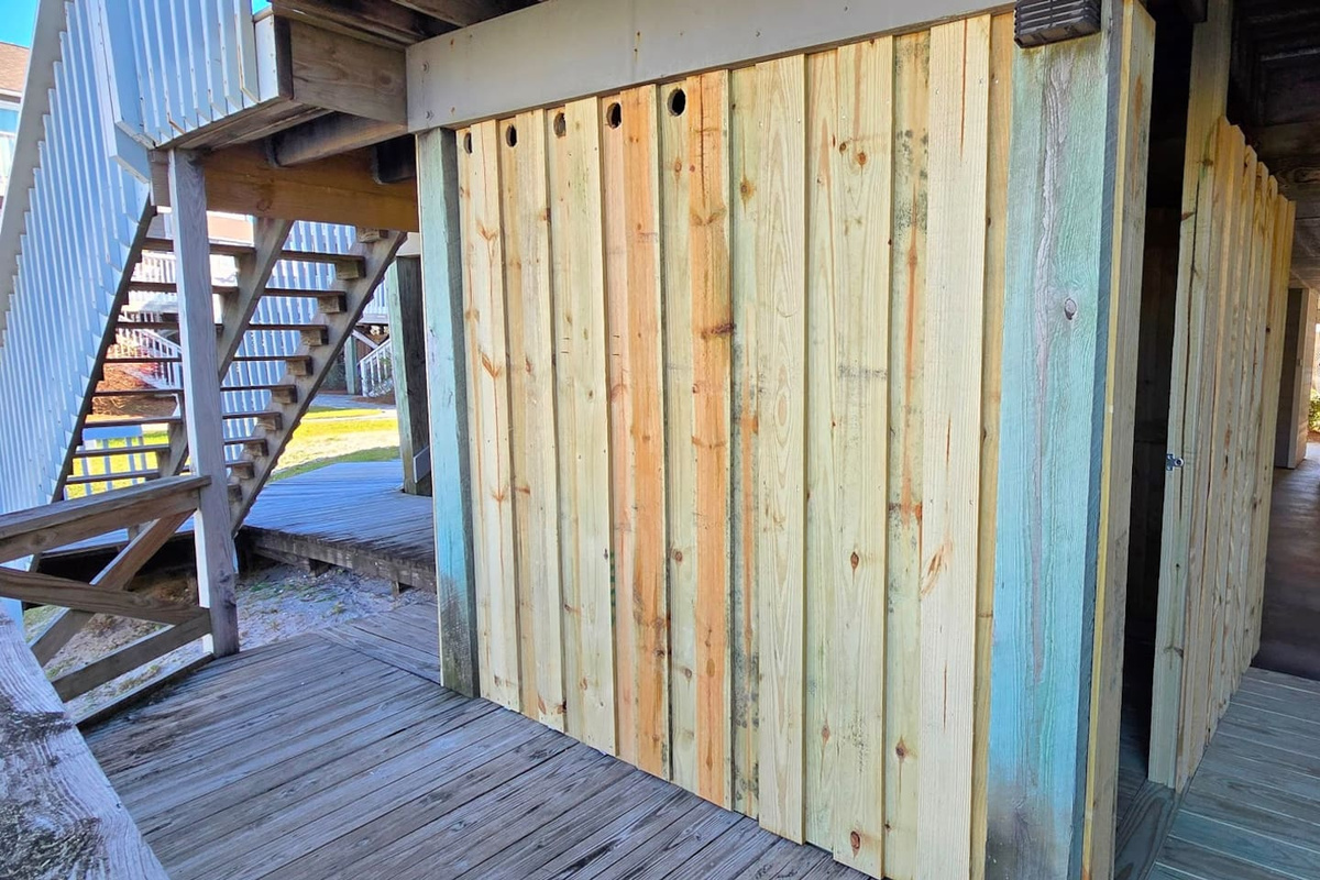 Step into the private outdoor shower enclosure and wash every grain of sand off before you even touch the door handle.
