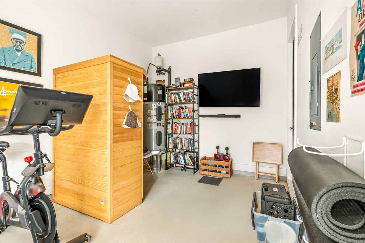Fully equipped home gym with exercise bike and stretching area