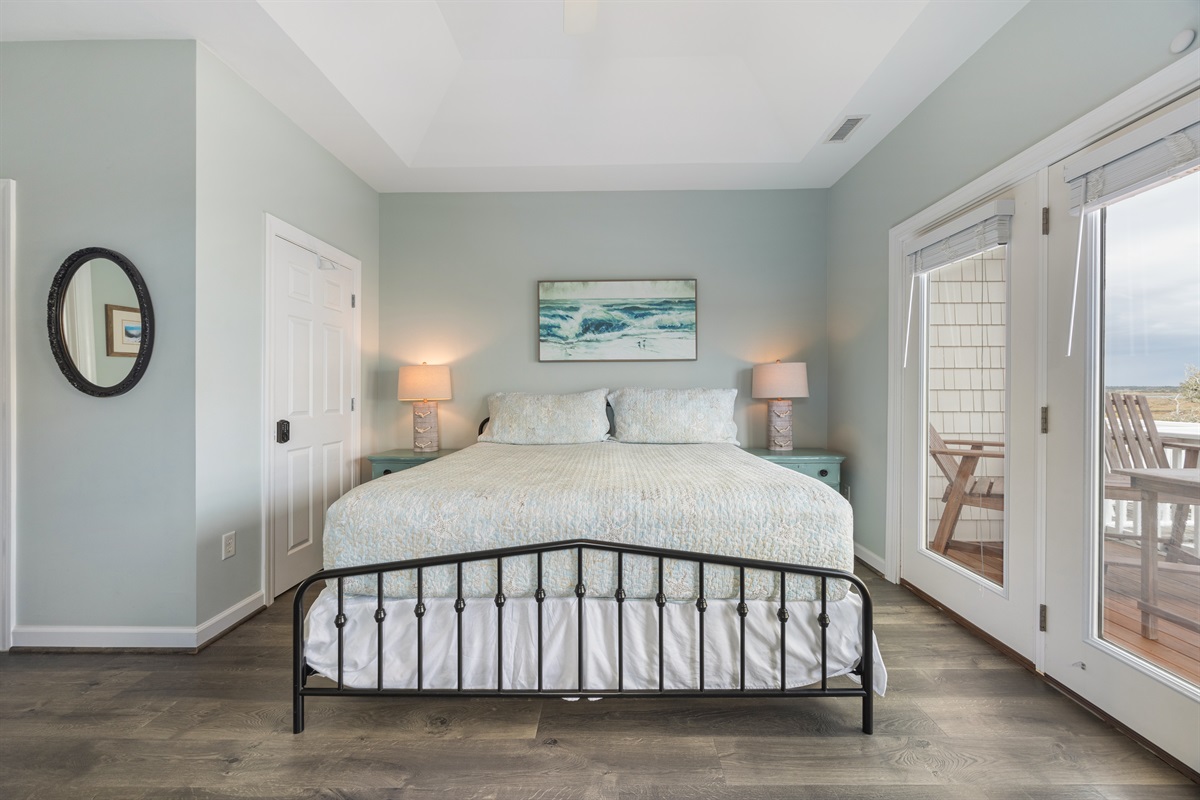 Beautiful king bedroom featuring plenty of natural light and cozy décor