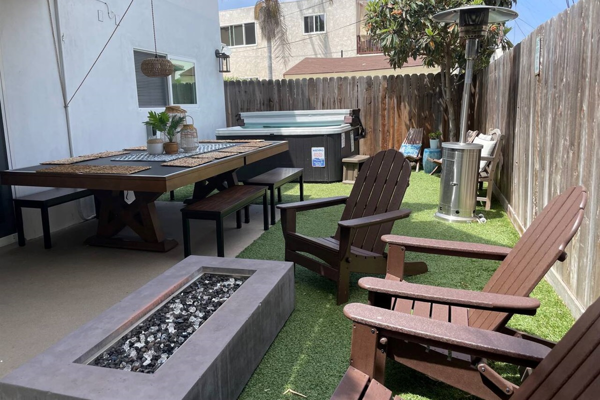 The private back yard has a hot tub, fire pit and a ping pong table that doubles as a dining table that seats 10!