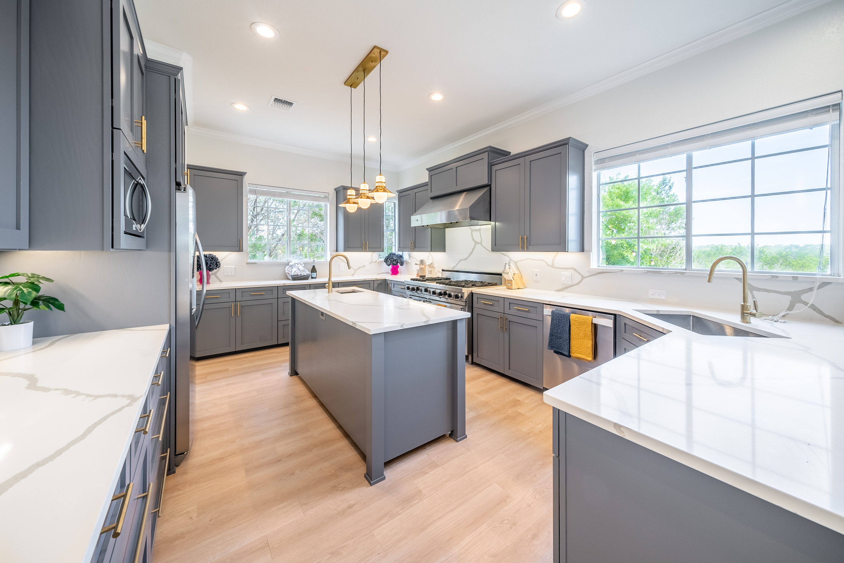 Two-tone cabinetry and pendant lighting add style to this chef-ready kitchen.