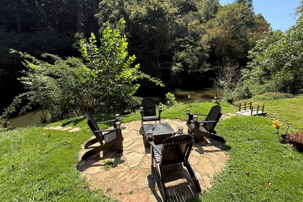 4 oversized Adirondack chairs in black, very roomy and super comfy to enjoy the fire pit at the river level.