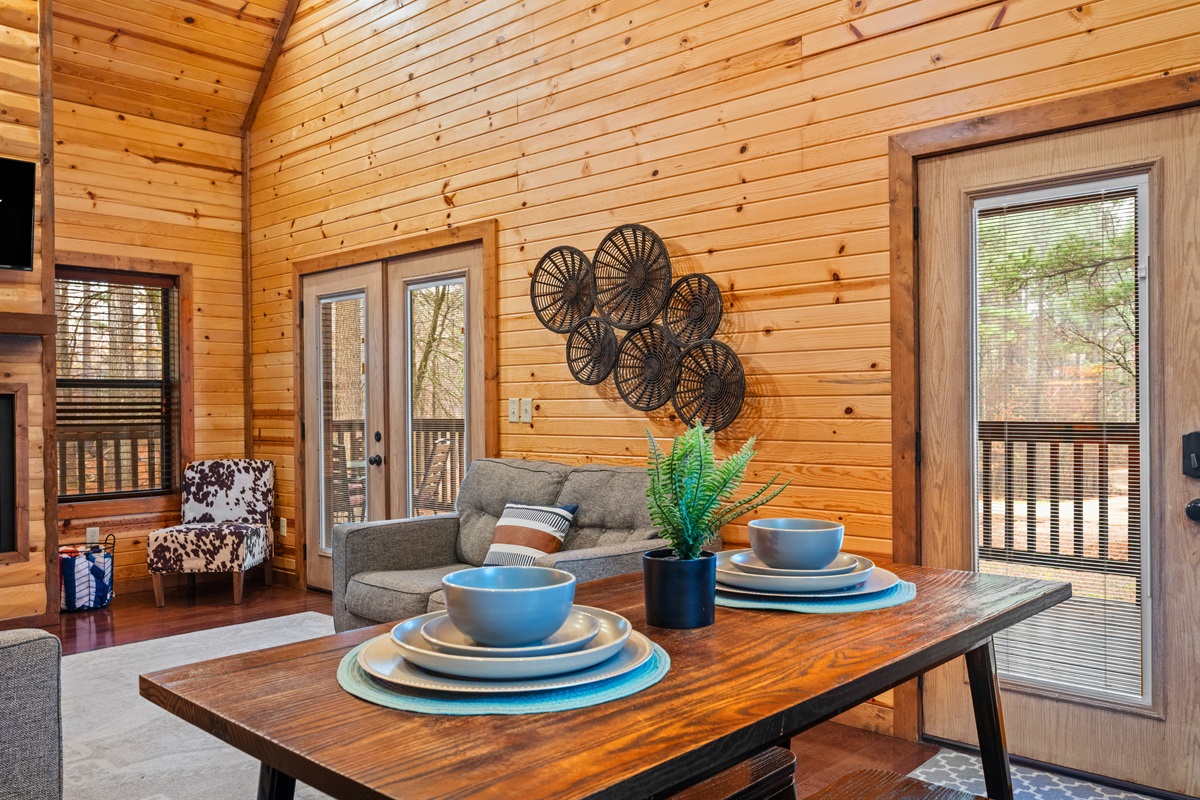 A closer look at the dining table shows a welcoming setup that’s ready for shared meals and memorable cabin moments.