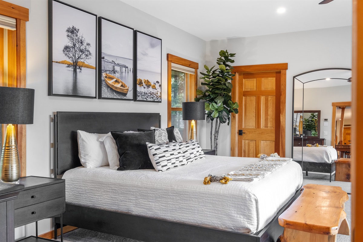 First floor master bedroom ensuite with king and twin beds overlooking Lake Winnipesaukee with hot tub on outside deck.