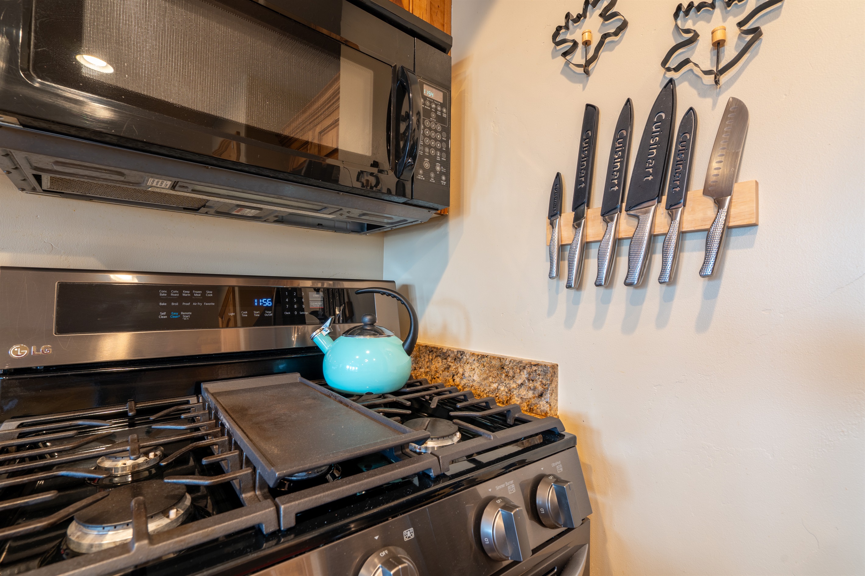 Fully equipped kitchen with gas range, microwave, and quality cookware for easy home-cooked meals.