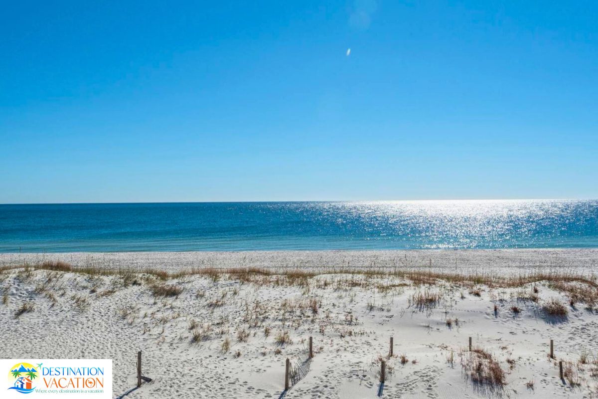 Where peaceful dunes meet sparkling blue waters.