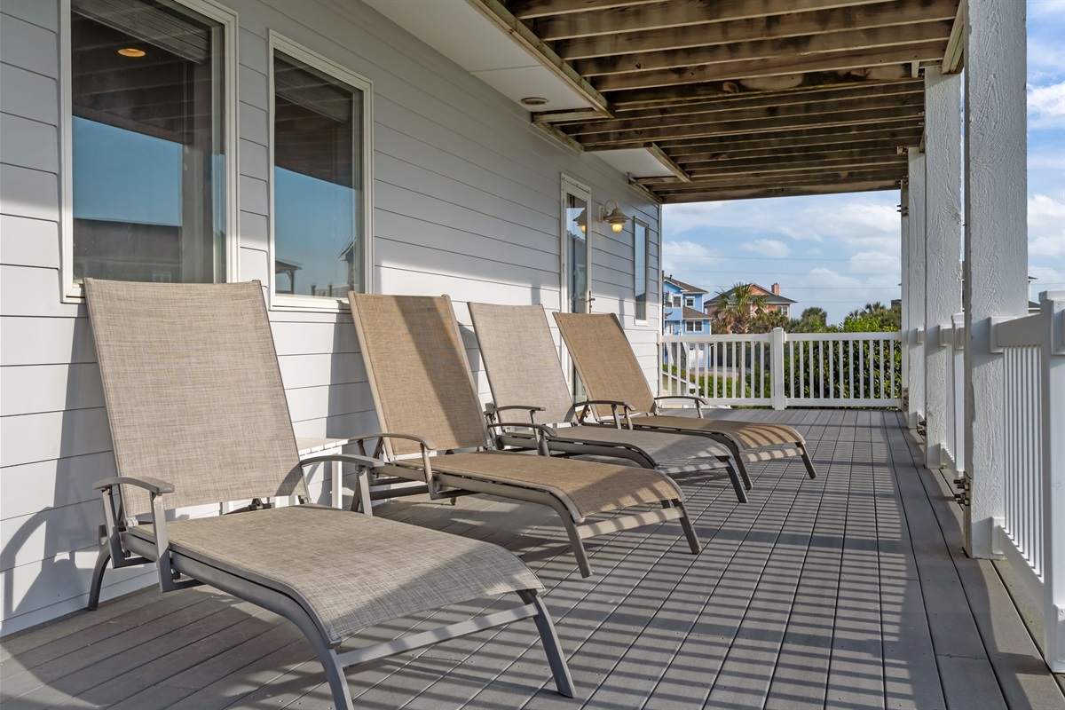 Wraparound deck with multiple loungers, ideal for sunbathing and relaxing outdoors