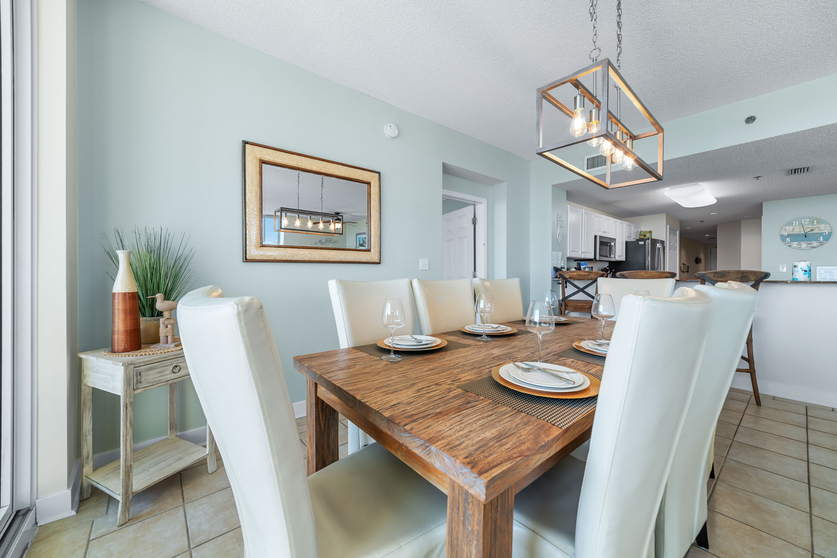 Enjoy effortless entertaining in this open-concept living and dining area, showcasing a modern chandelier, plush seating, and stunning natural light.