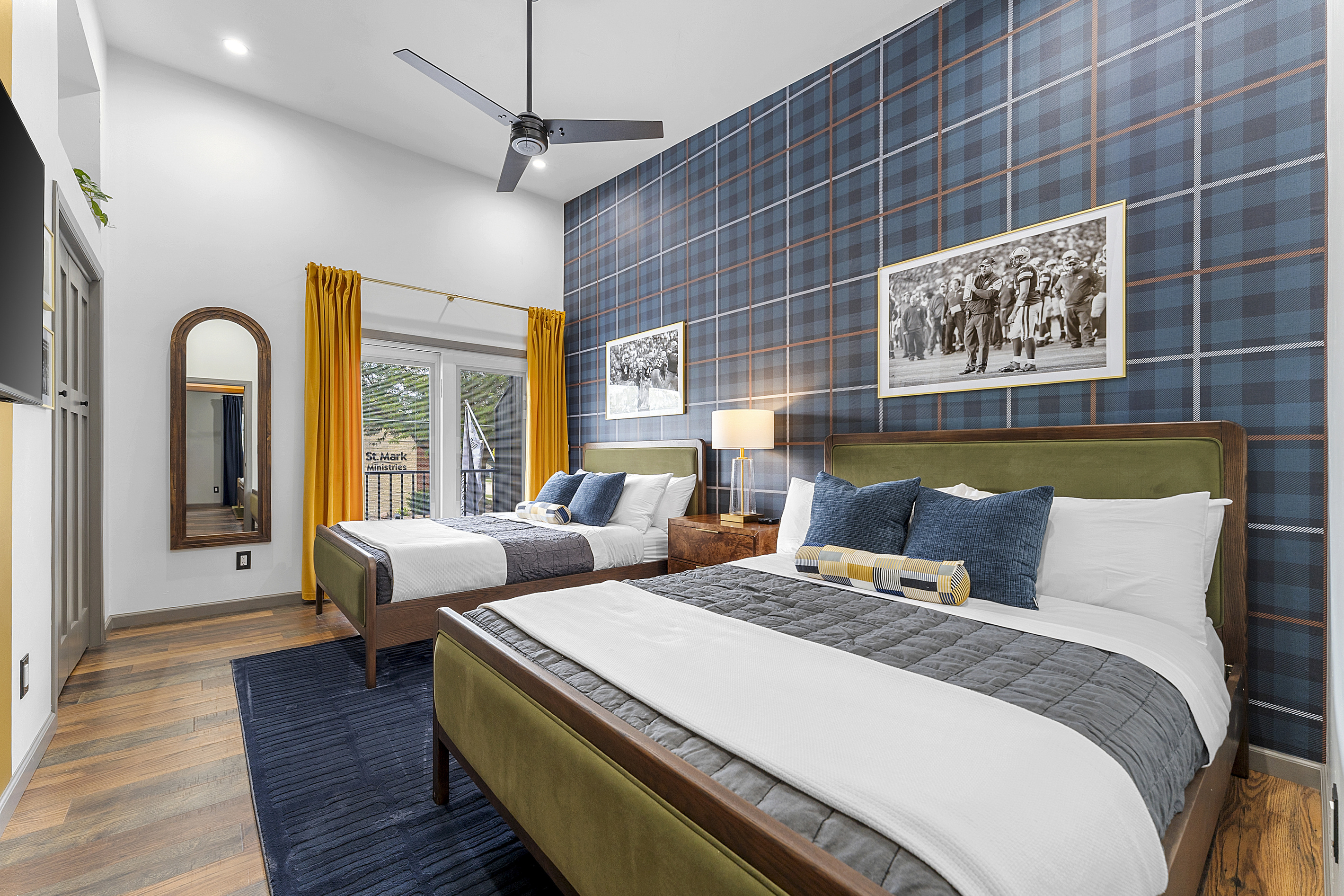 Spacious bedroom with two queen beds, ideal for families and groups.
