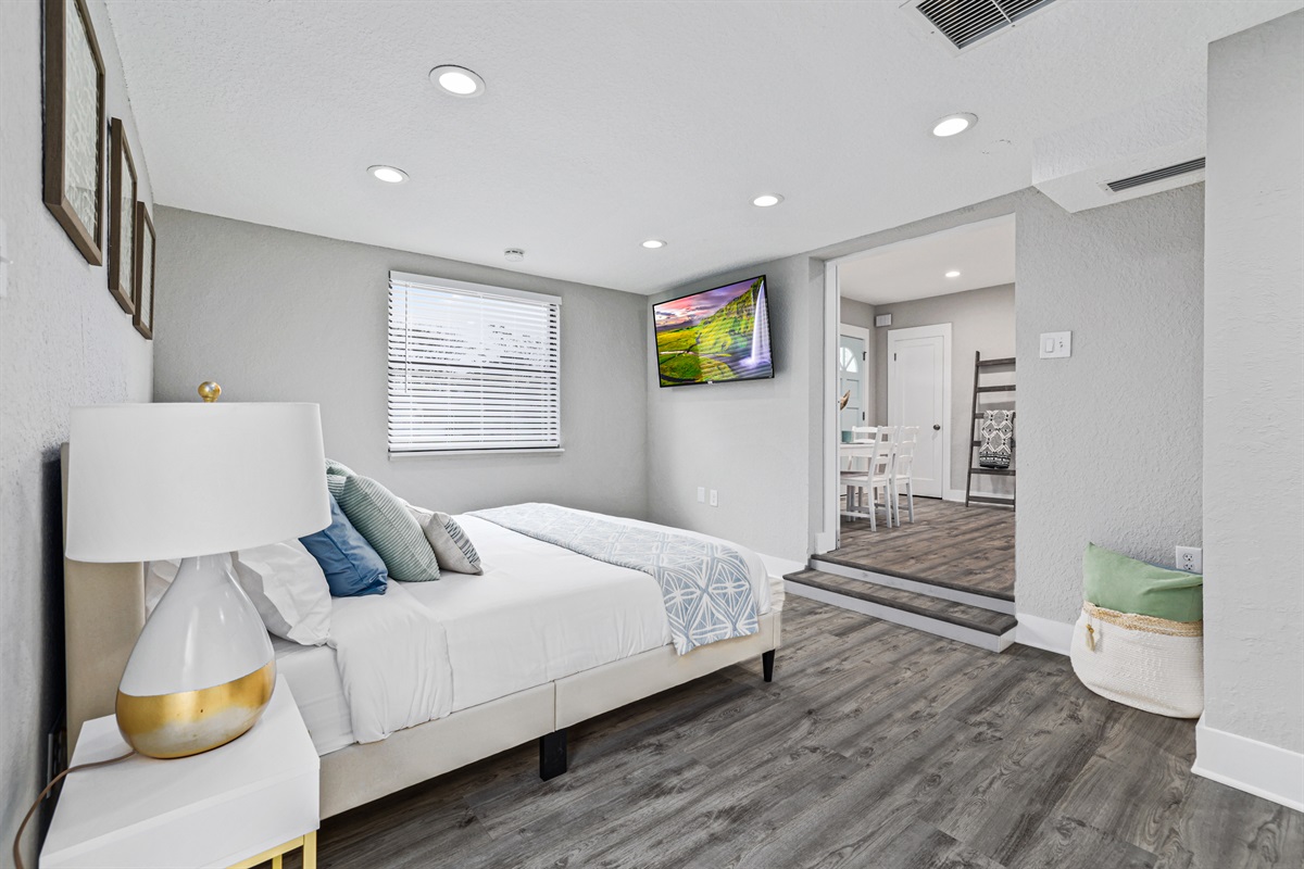 Primary bedroom with king sized bed and smart TV