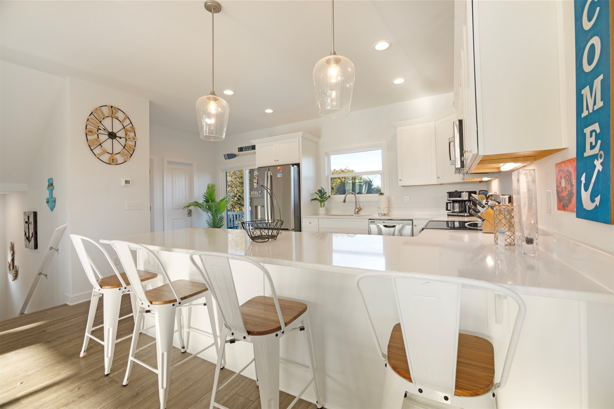 Large, open kitchen with ample counter space and bar seating for four