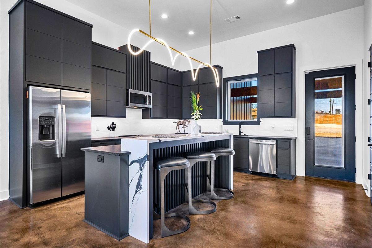 A seamless blend of elegance and functionality, this open-concept kitchen and dining area features sleek finishes, a spacious island, and thoughtful design touches.