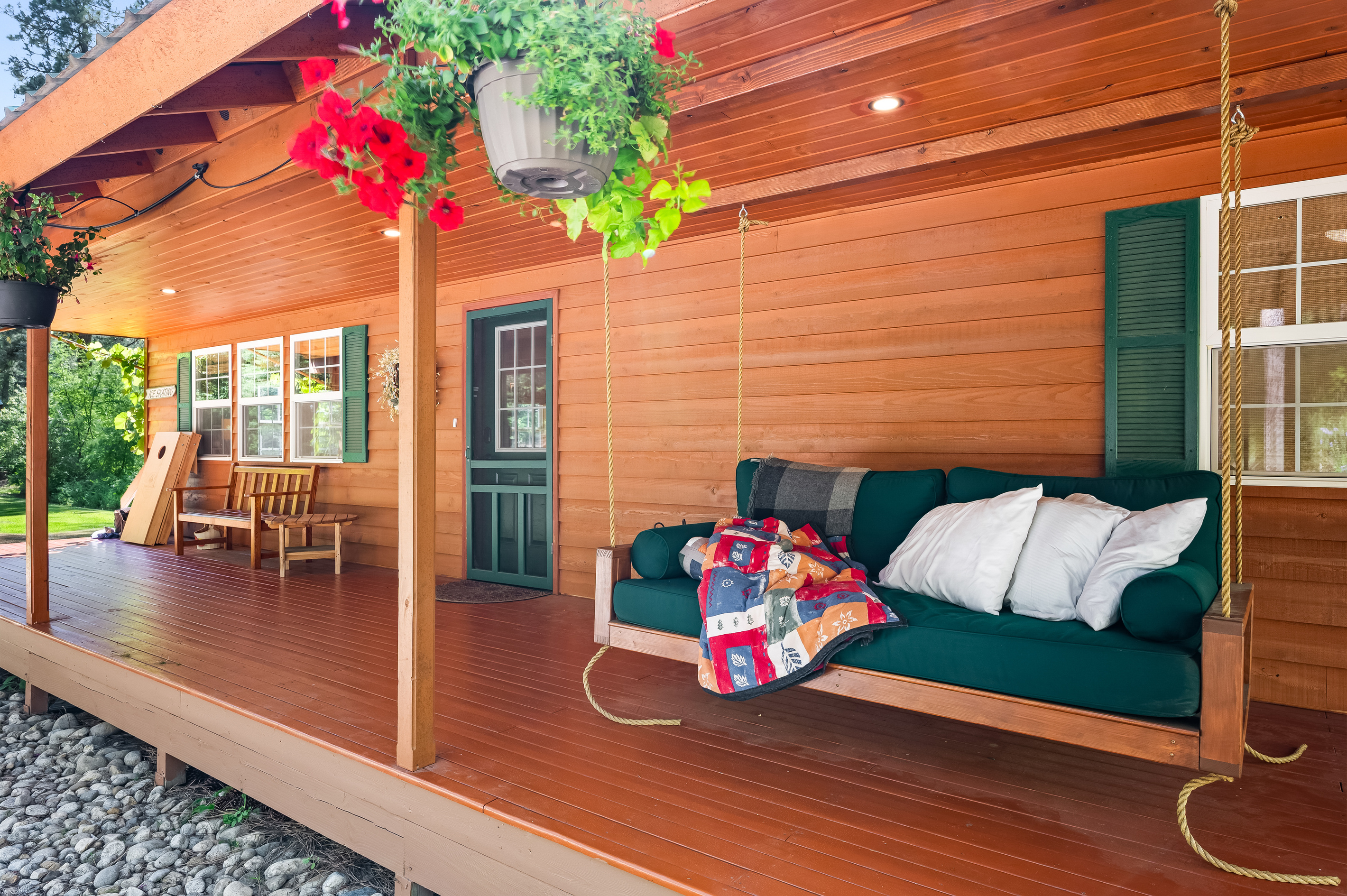 Front porch with seating and hanging day bed perfect for afternoon siestas
