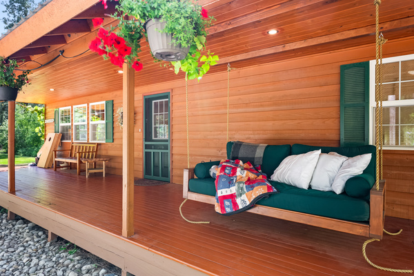 Front porch with seating and hanging day bed perfect for afternoon siestas