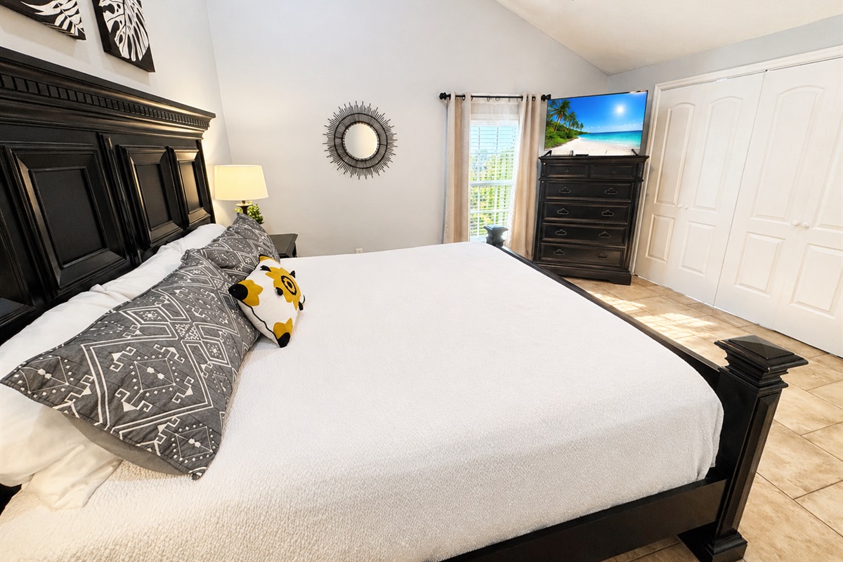 Master bedroom with king bed and vaulted ceilings