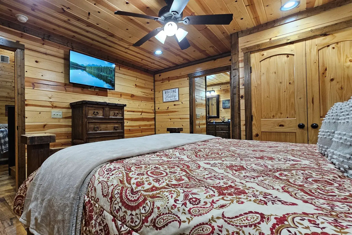 Bedroom 2: Rustic charm with wooden accents and plush bedding for a perfect getaway!