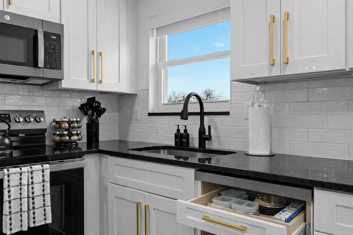 Sleek kitchen workspace with modern sink, ample counter space, and organized storage—perfect for prepping meals with ease and comfort.