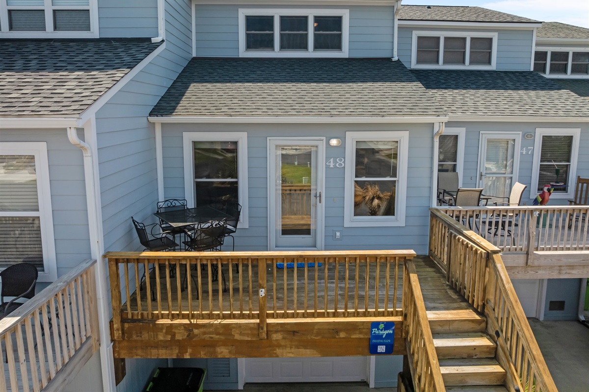 Private deck entrance with outdoor dining area