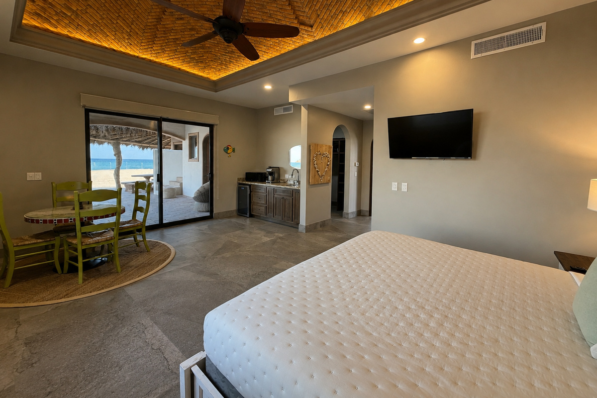 Casita 3: This private guest casita features a king-size bed, Smart TV, ceiling fan, and direct patio access. The well-equipped kitchenette includes a sink, coffee maker, microwave, mini refrigerator, and dining table for four.