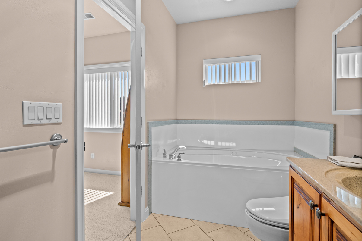 Spa-inspired primary bathroom with soaking tub, double vanity, and elegant finishes.