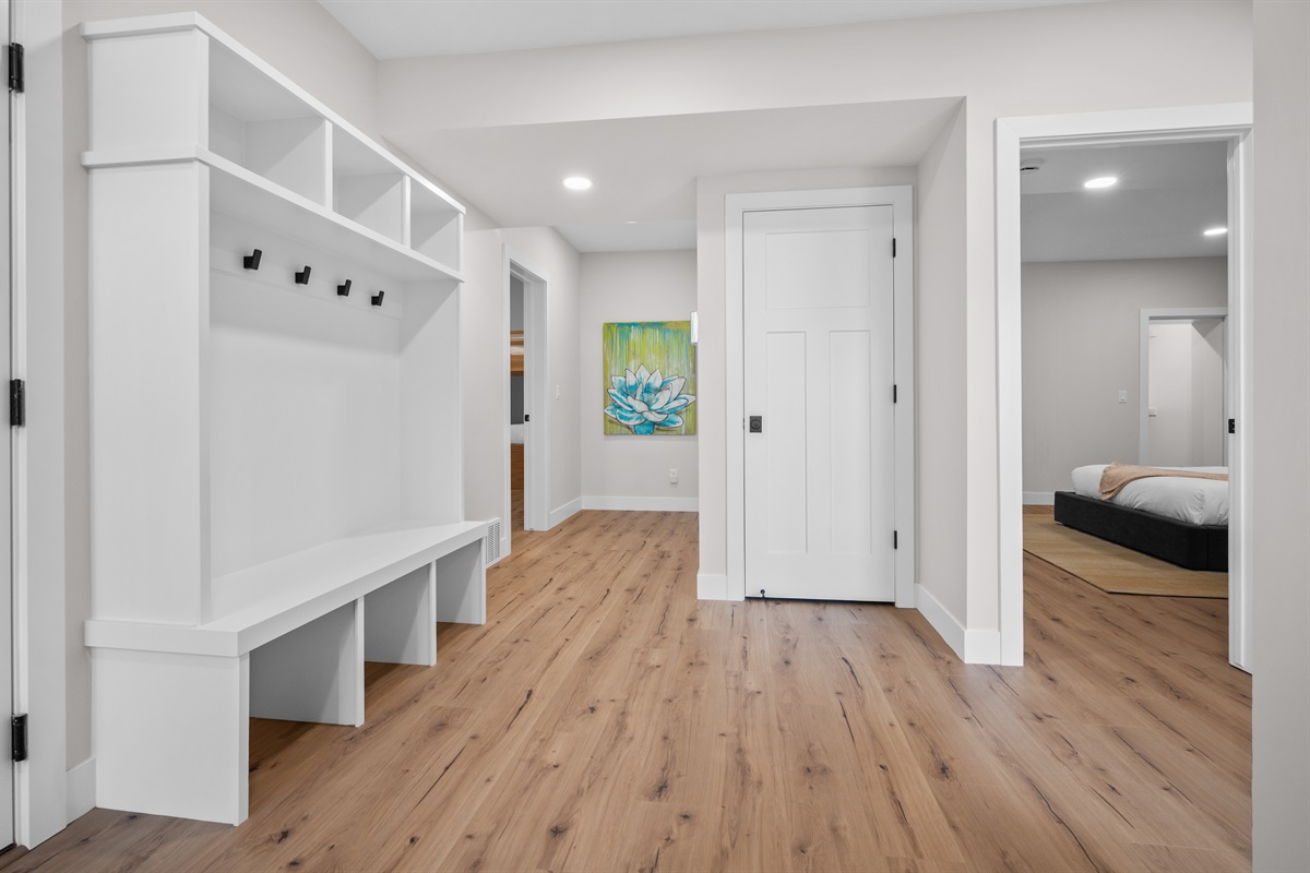 Welcoming lower-level entry with built-in bench and hooks — ideal for coats and gear.
