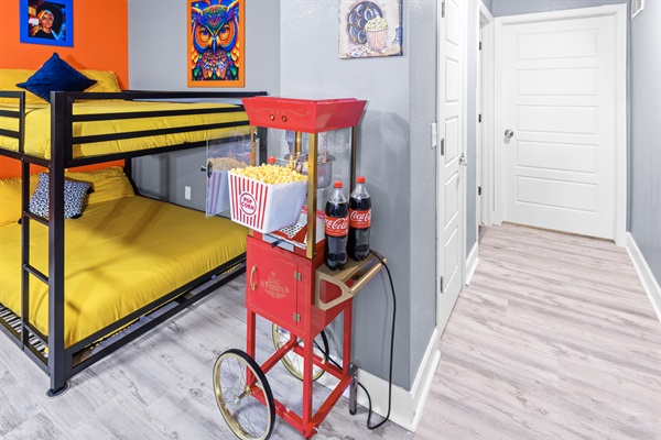 Bedroom 4 offers 4 cozy bunk beds, striking artwork, a relaxing massage chair, and a popcorn machine—perfect for a playful and relaxing stay!