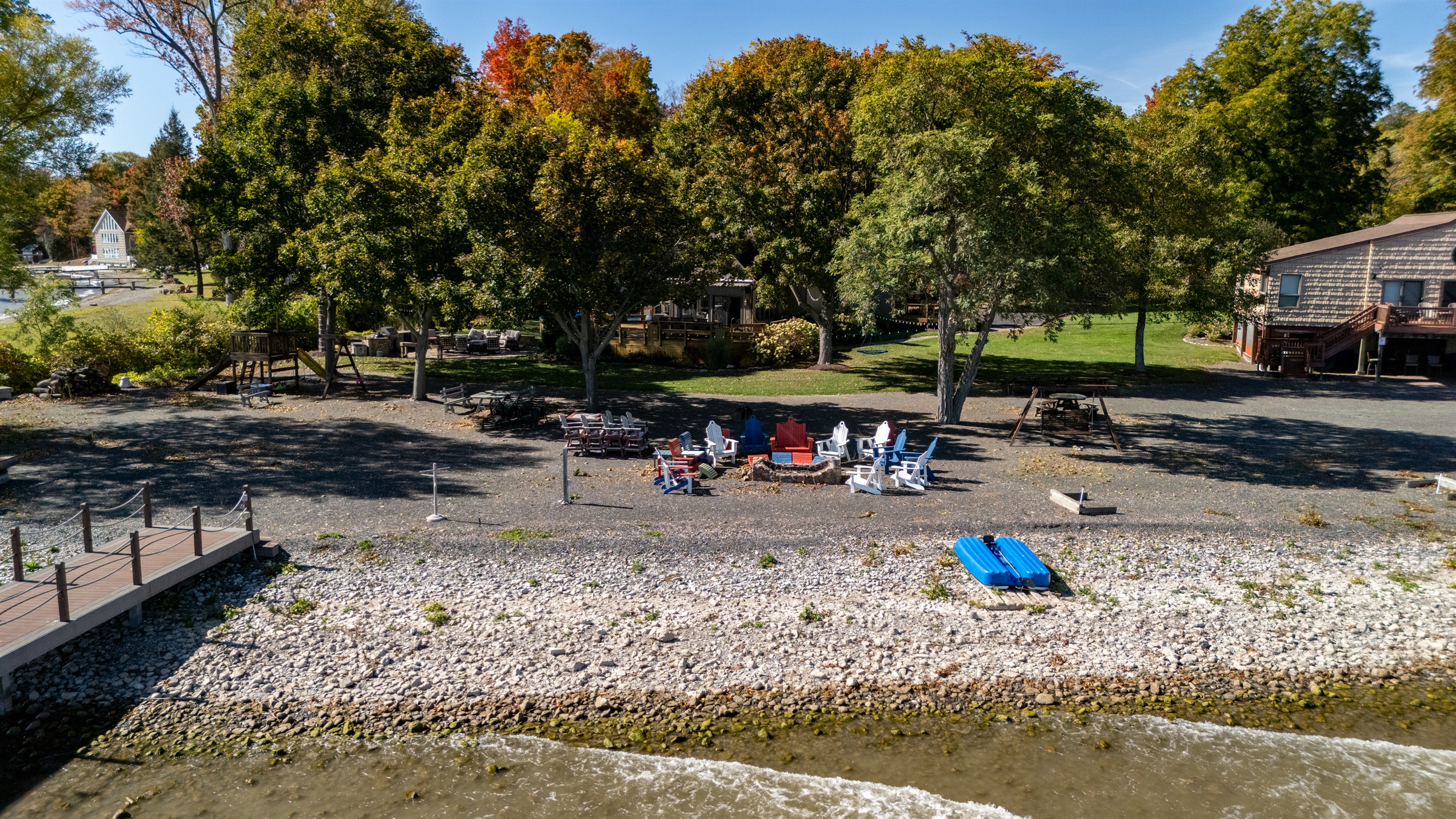 Relax on your private lakeside shoreline with cozy Adirondack seating and calm waterfront views.
