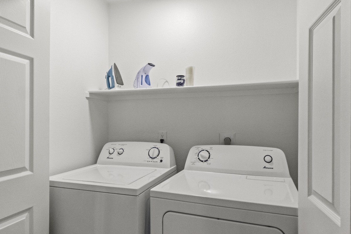 Laundry area with washer and dryer. Free detergent and dryer sheet is provided too. 