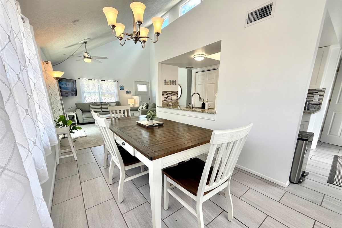 Gather around the dining table for breakfast, lunch, or dinner in this inviting space with a warm, homey vibe.
