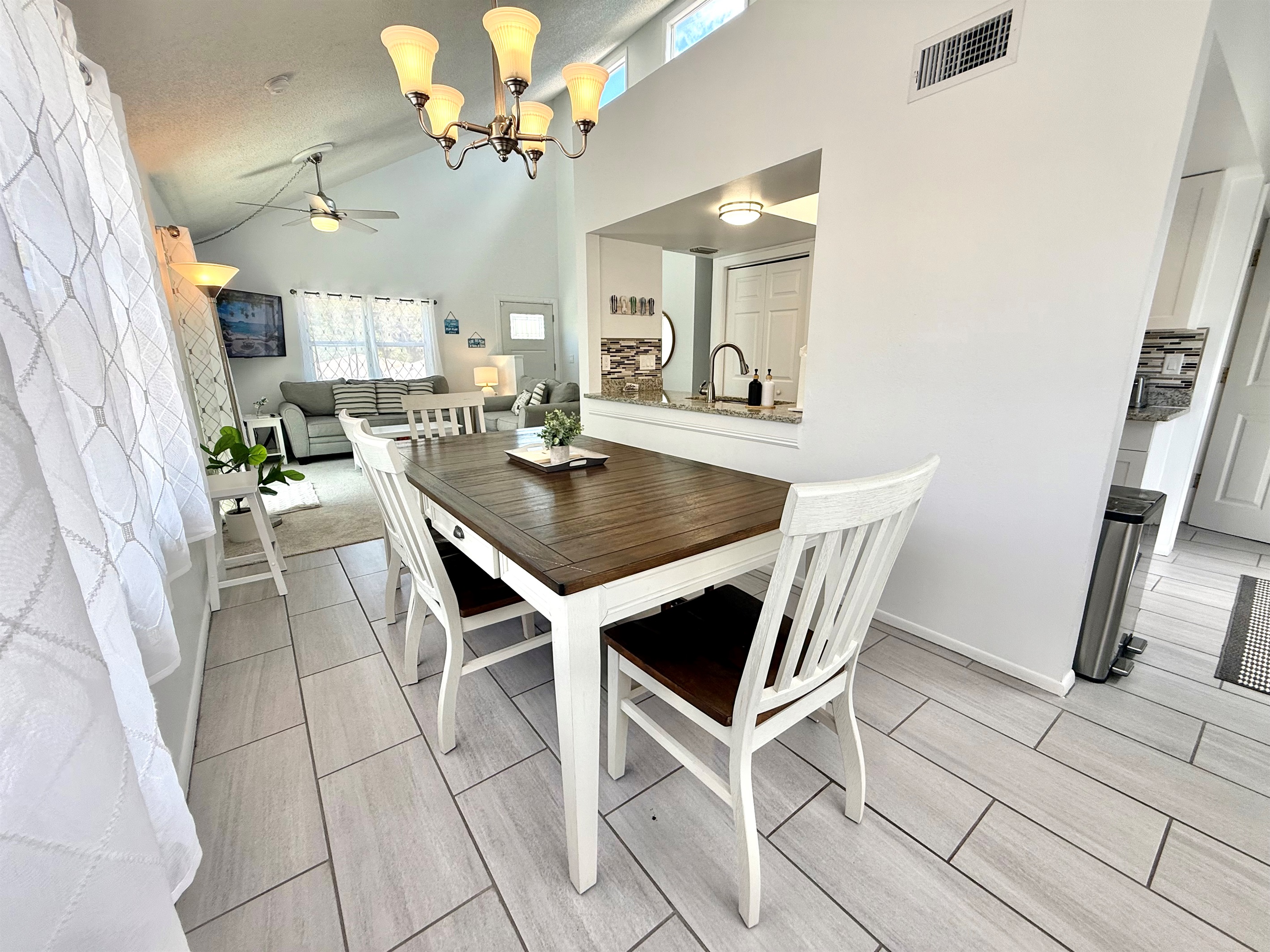 Gather around the dining table for breakfast, lunch, or dinner in this inviting space with a warm, homey vibe.