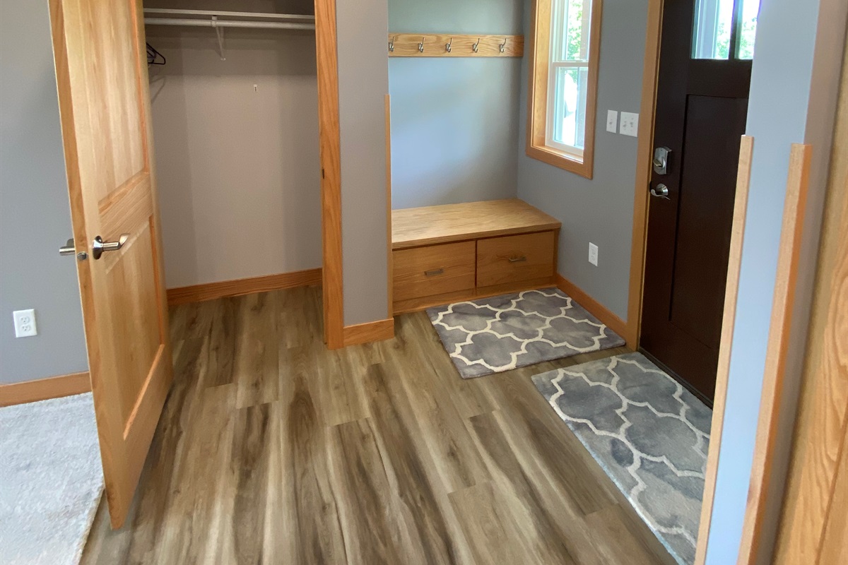 Front door area with nice sit down and closet space 