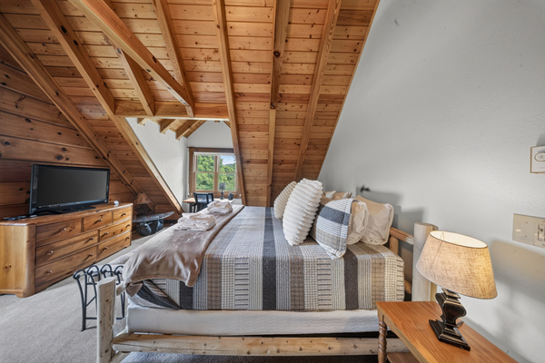 Spacious primary with memory foam king bed, Roku TV and private balcony. 