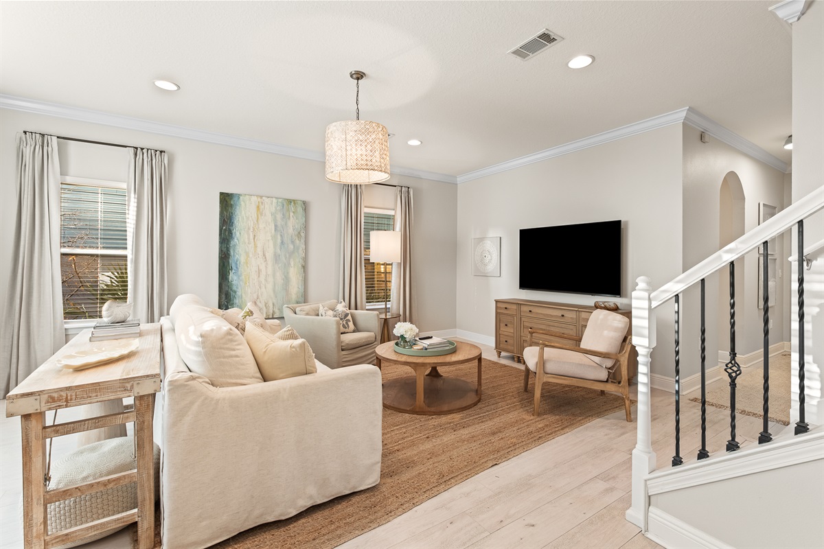 Living Room 1: Sun-drenched and spacious, this inviting lounge is one of two living areas perfect for gathering with family.