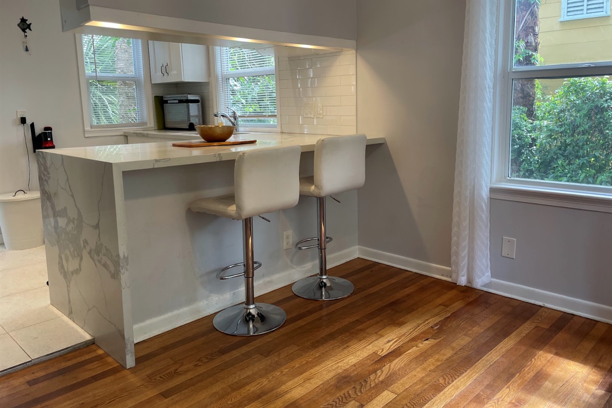Two counter stools sit in the kitchen, a convenient place to enjoy coffee or breakfast.