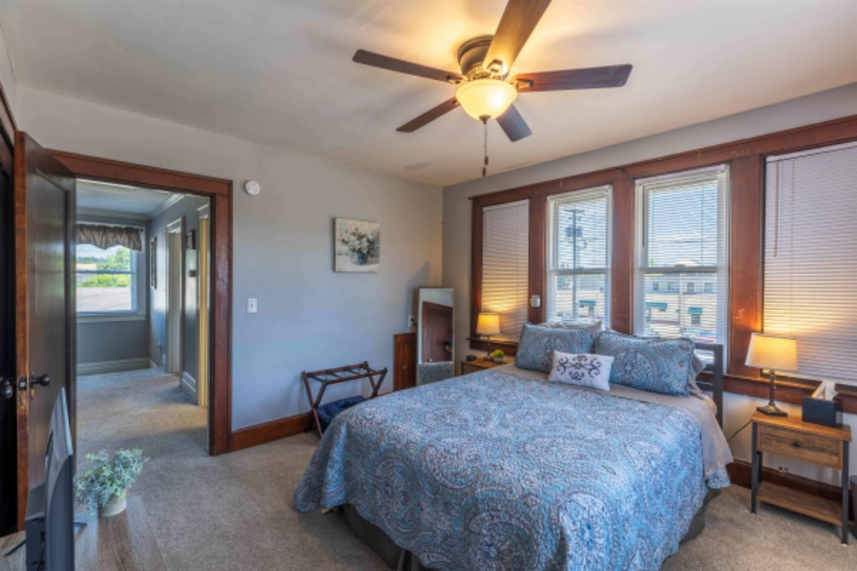 Enjoy a light‑filled bedroom with plenty of windows and a welcoming queen bed.