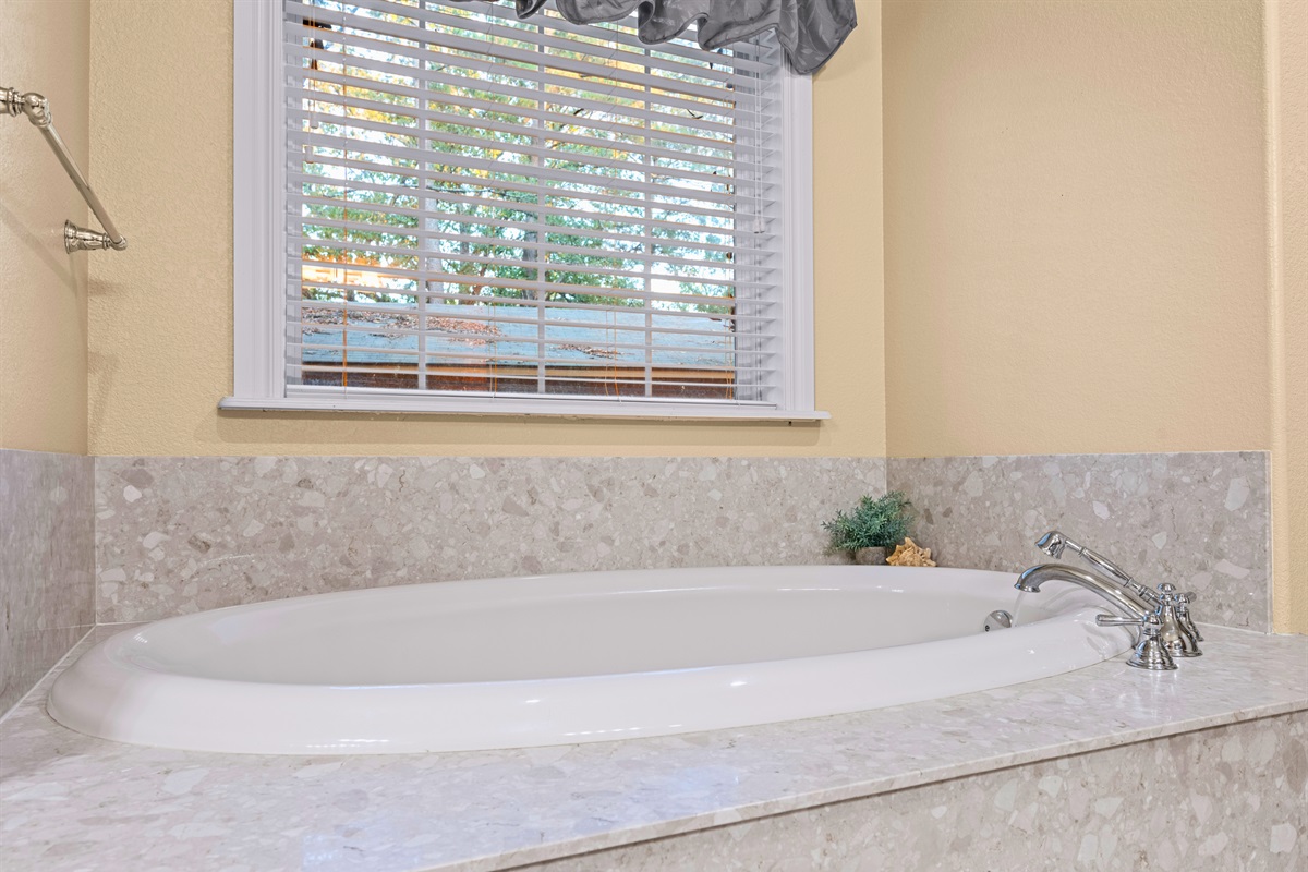 Luxurious soaking tub in master bathroom.