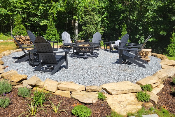 Gather with friends & family at the firepit, with 8 classic Adirondack chairs + side tables on a gravel pad and a boulder border. Whether you're roasting marshmallows, sharing stories, or stargazing, this cozy outdoor setup is made for unforgetable moments