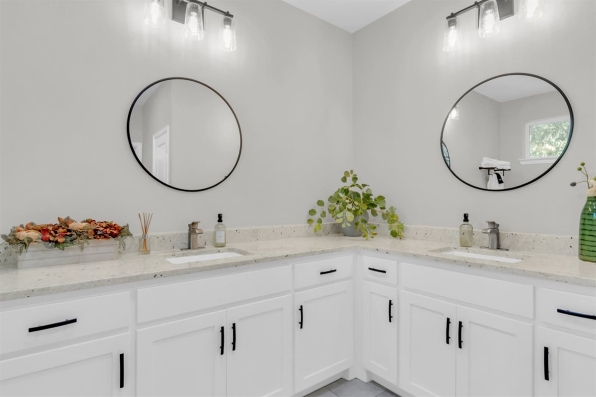 Spa-inspired bathroom with walk-in shower, dual vanity, and premium essential bath products.