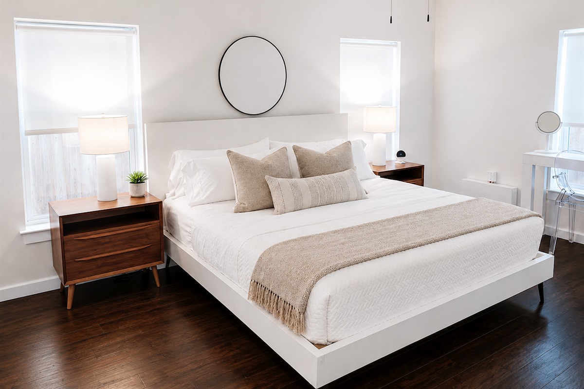 Serene primary bedroom with king bed, luxe linens, blackout shades, and calming modern décor