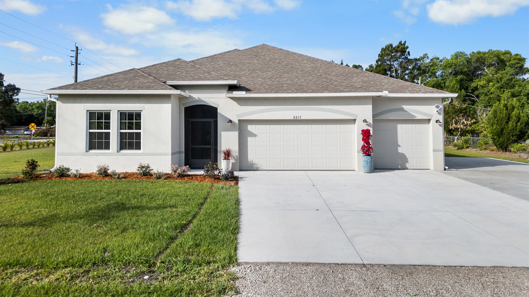 Large yard and 3 car garage with plenty of driveway parking
