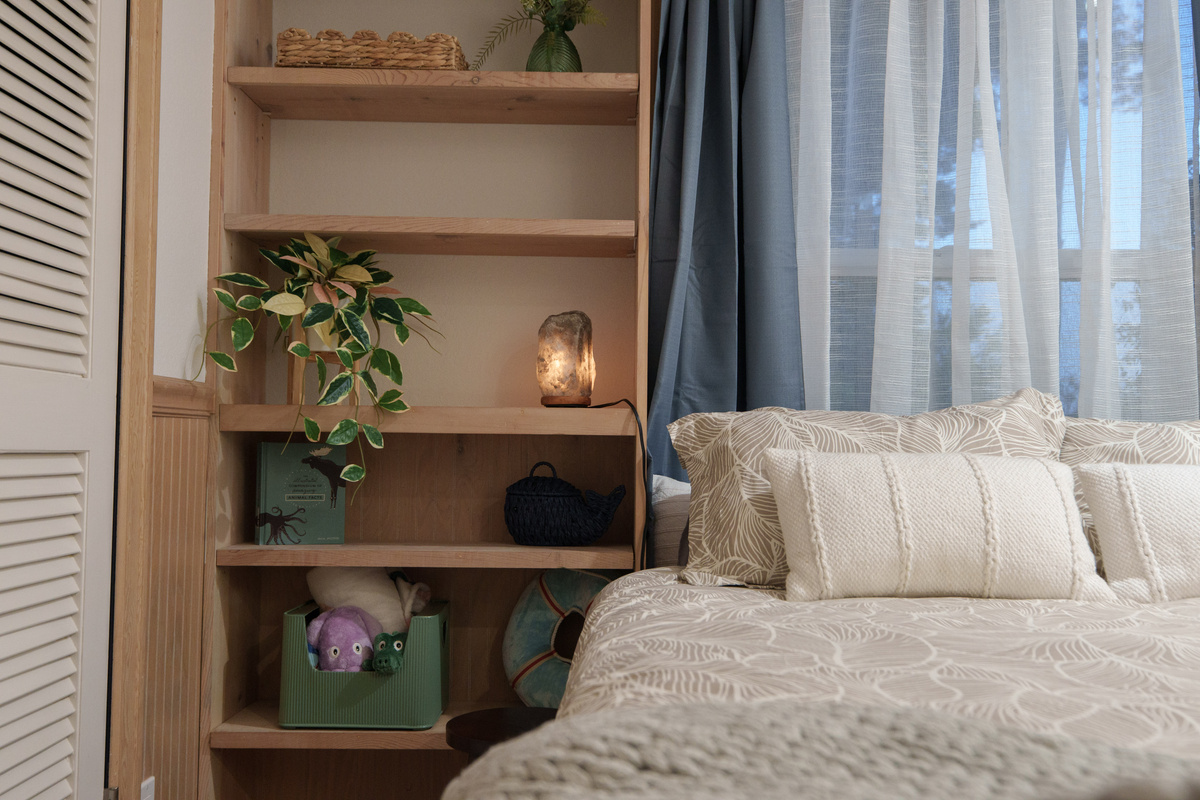 Bedroom 3 offers a comfortable queen bed for two, built-in shelving, and direct access to Bathroom 3, which is shared with Bedroom 4.
