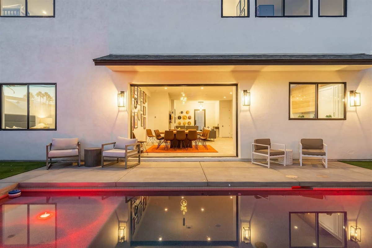 Relax by the beautiful pool, featuring ample seating, a shaded pergola with a grill area, and dining tables for perfect al fresco meals. A serene spot to unwind and enjoy outdoor living!