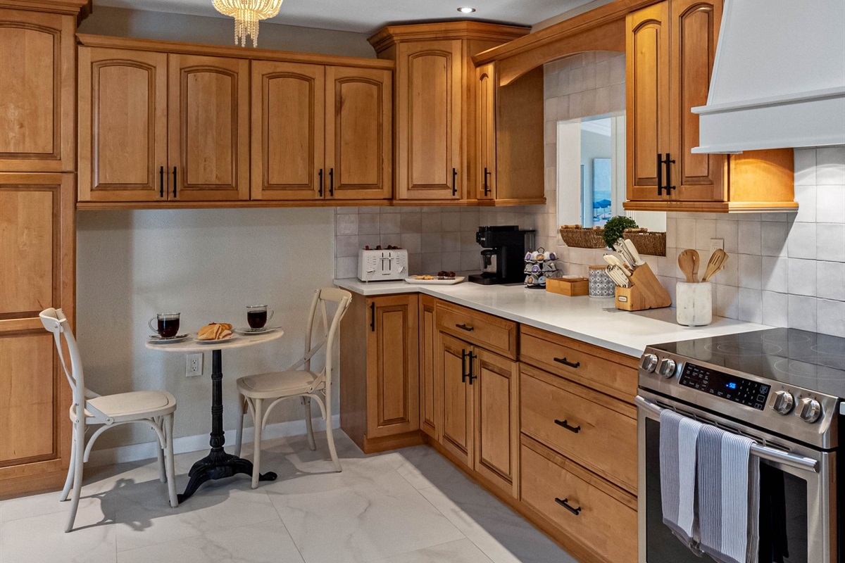 This kitchen features warm wood cabinetry, sleek quartz countertops, and stainless-steel appliances for a perfect blend of style and function.