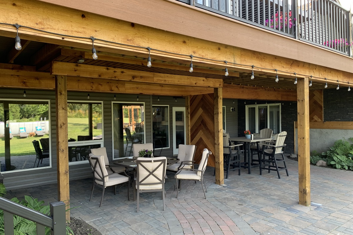 WALKOUT PATIO. LOTS OF SEATING IN THE LOWER PATIO TO GET OUT OF THE SUN OR TAKE SHELTER FROM A LITTLE RAIN. TABLE UNDER EXERCISE ROOM AND COUCHES DO NOT GET WET.