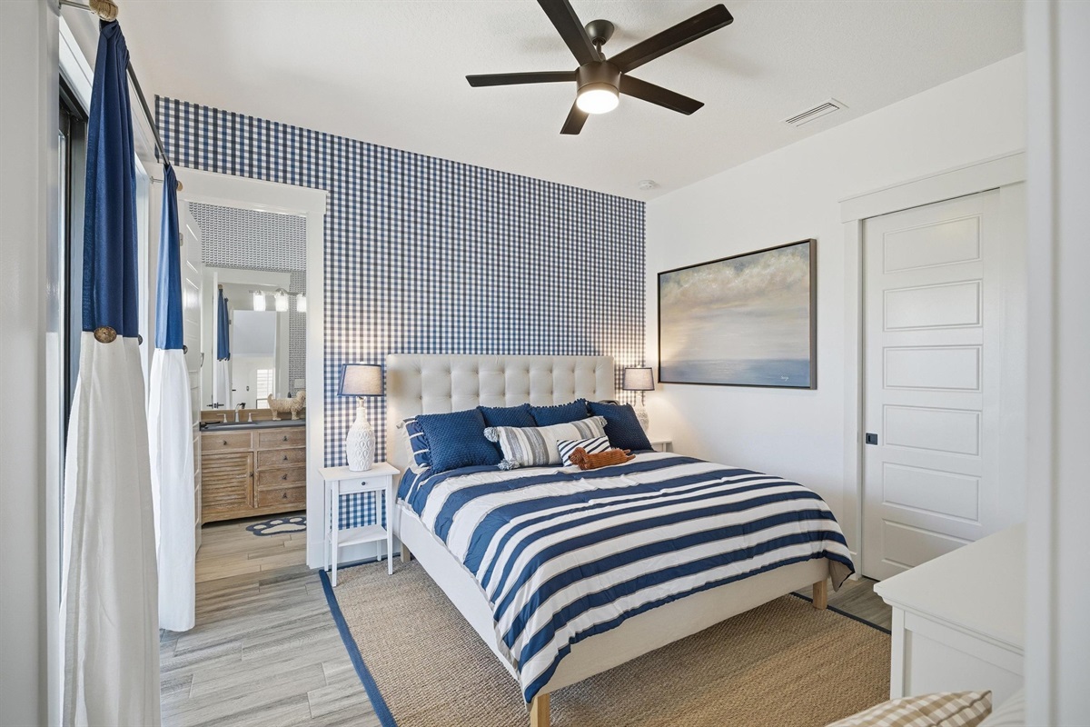 Coastal comfort, perfected 🌊🛏️
Drift off in this serene blue-and-white bedroom with crisp linens, soft lighting, and a private en-suite bath—your own peaceful retreat after a day at the beach.