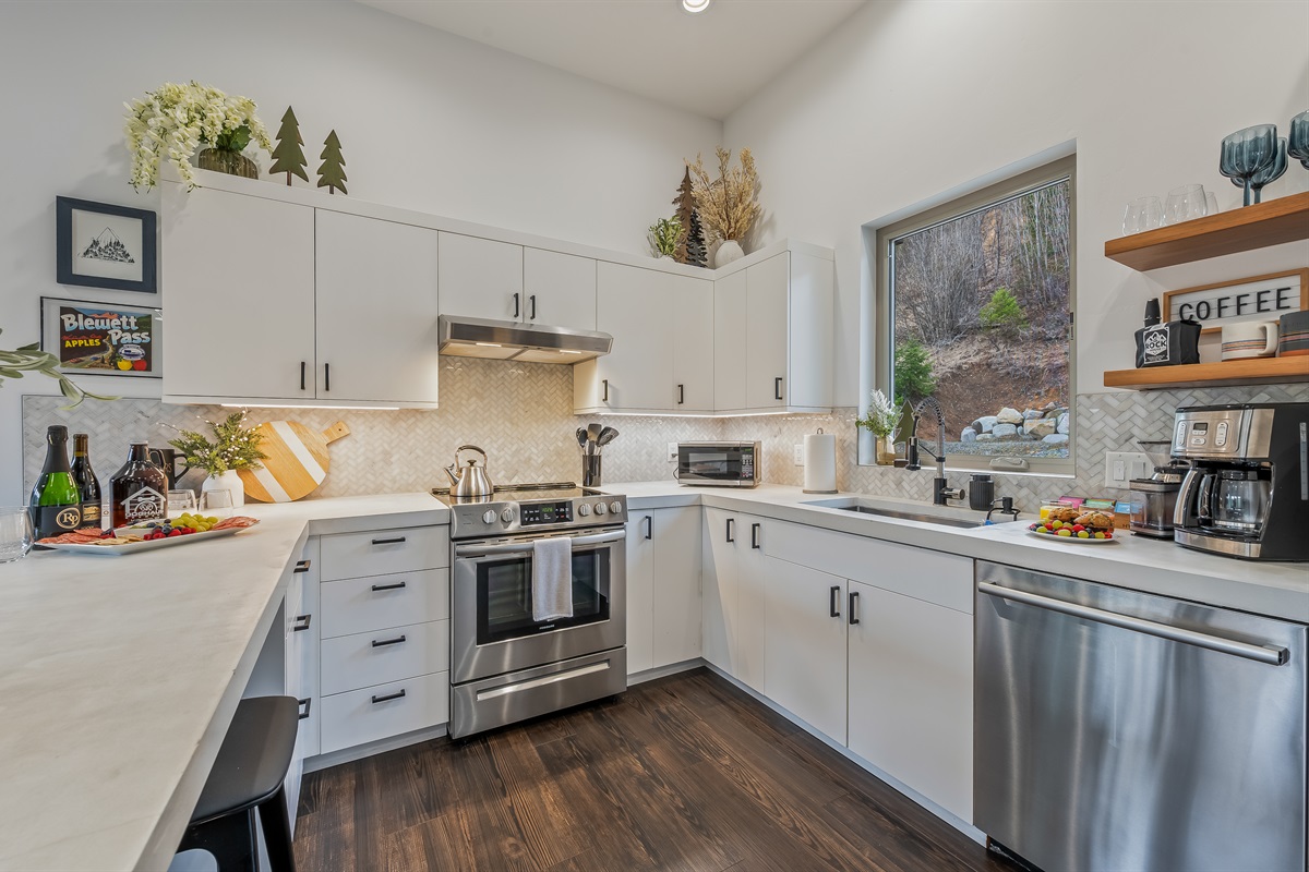 Spacious open layout with living room, fully loaded kitchen, island with dining seating for 4