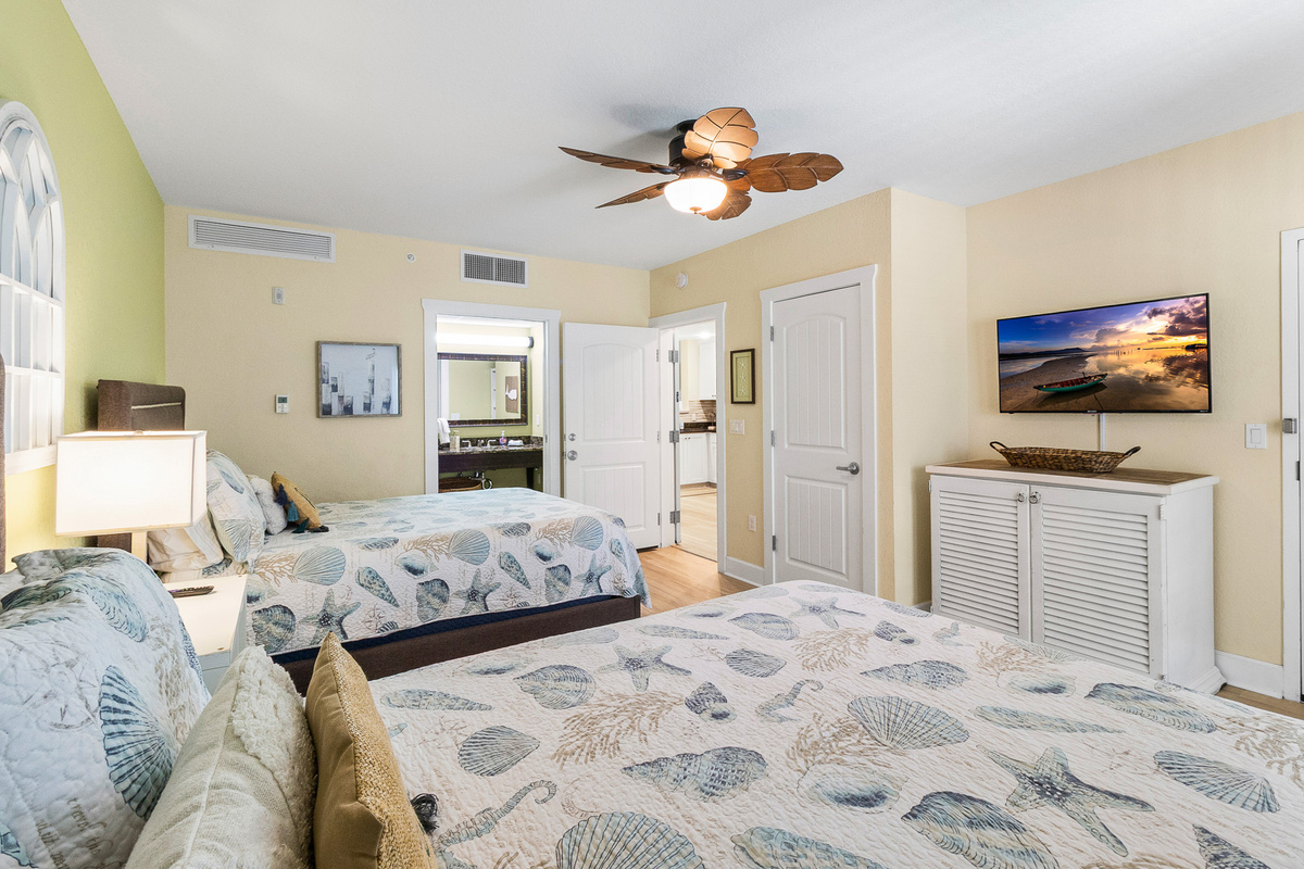 Bedroom 2, ensuite bath, with a door that leads to the front balcony, and the exterior hallway.
