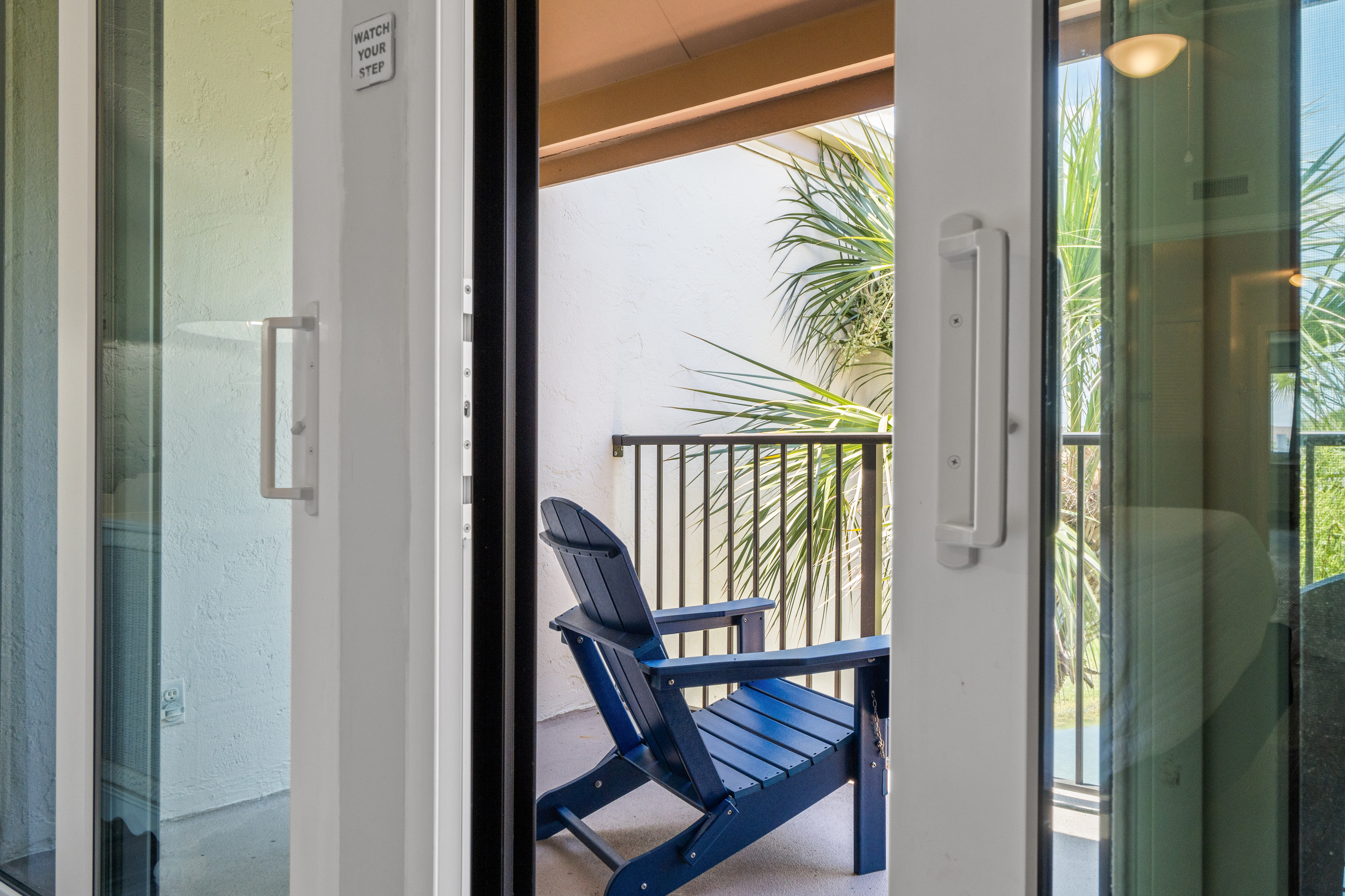 Balcony off of Bedroom 1 with outdoor seating. 