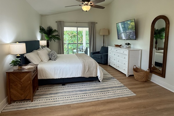 Experience secluded luxury in this spacious King suite, featuring an open layout and a private backdrop of lush foliage